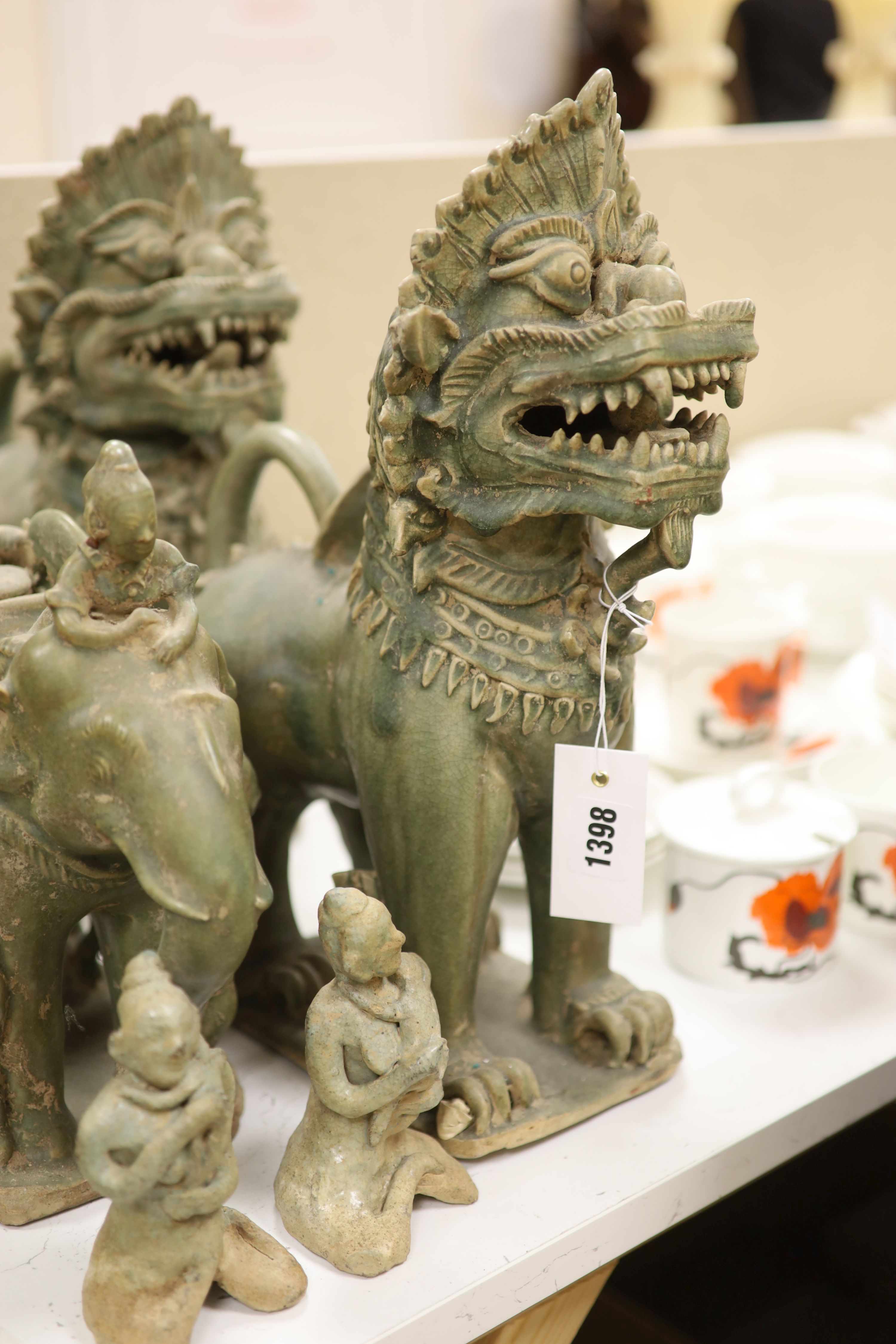 A group of Thai celadon glazed figures, temple dogs height 40cm
